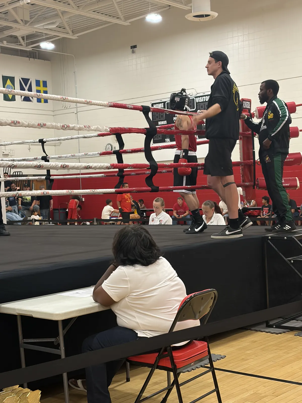 A coach watching from ringside at a tournament