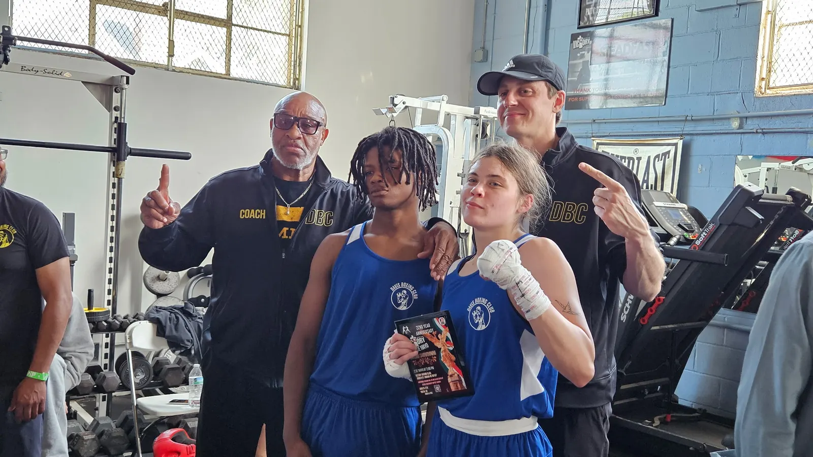 Coaches and boxers celebrating after a bout