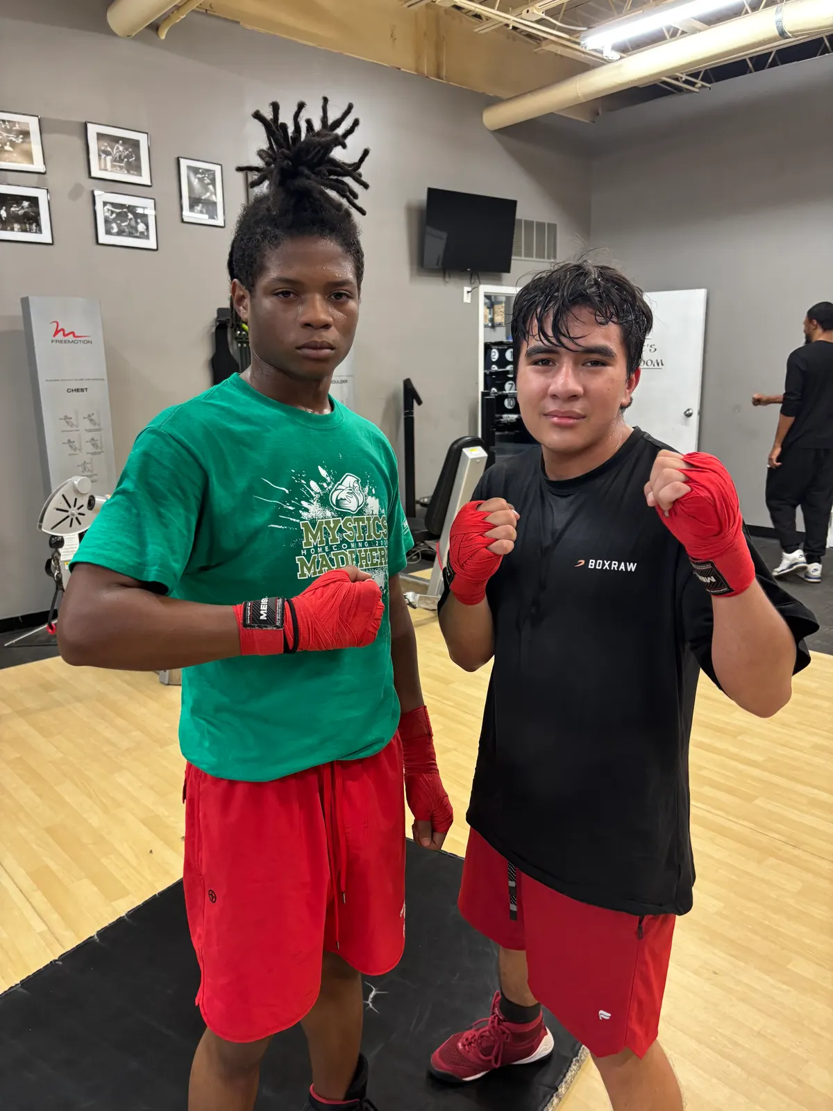 Two young boxers posing with their gloves on